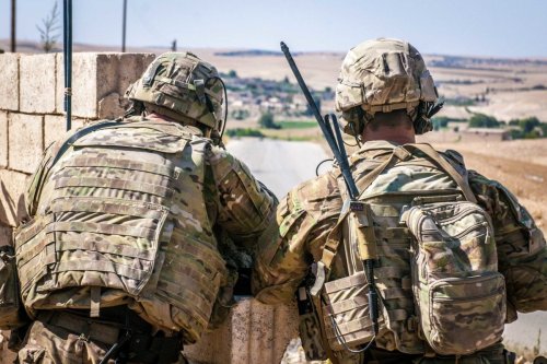 Two US Soldiers keep an eye on the demarcation line during a security patrol outside Manbij, Syria, on 26 June 2018. [US Army - Staff Sgt. Timothy R. Koster]