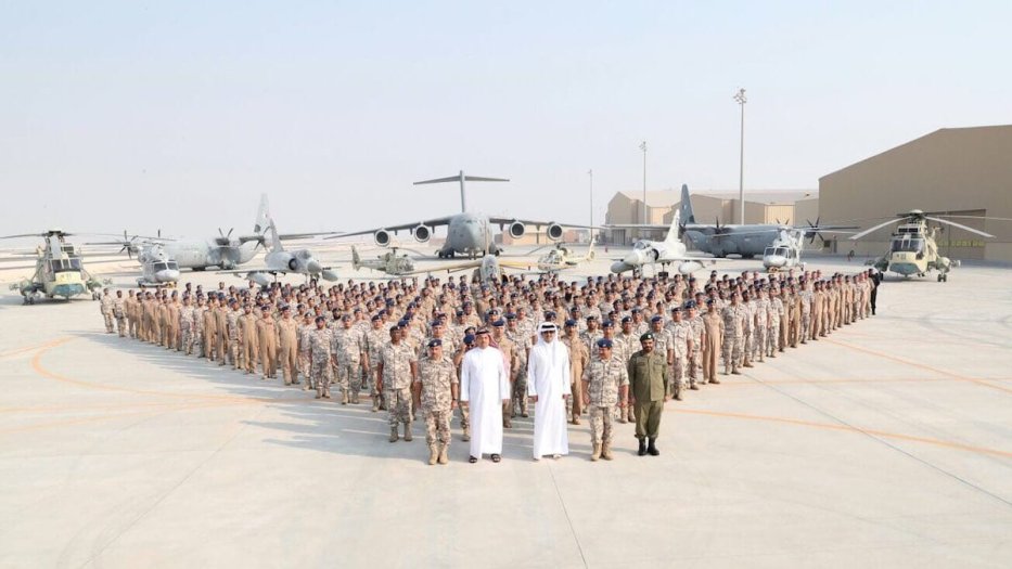 Qatari Sheikh Tamim bin Hamad Al Thani, Minister of State for Defence of Qatar, Khalid bin Mohammad Al Attiyah and Qatari Chief of the Army Mubarak Mohammed Al Khayareen pose for a photo with soldiers as part of their visit to US Combined Air Operations Center of Qatar (CAOC) at Al Udeid Air Base in Doha, Qatar on September 11, 2017 [Qatari Defense Ministry / Handout - Anadolu Agency]