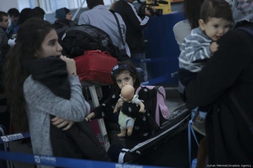 Children are seen at Athens International Airport as 234 refugees are transferred to Lyon of France within the EU Relocation Programme of International Organization for Migration (IOM) in Athens, Greece on 18 October, 2017 [Ayhan Mehmet/Anadolu Agency]