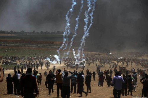 Palestinian protesters gather during clashes with Israeli security froces in a tent city protest where Palestinians demand the right to return to their homeland, on the occasion of the 70th anniversary of the "Nakba", and against U.S. embassy move to Jerusalem at the Israel-Gaza border, in Beit Lahia, in the northern of Gaza Strip, on 14 May, 2018 [Ramez Habboub/Apaimages]