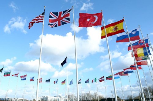 Flags of members of North Atlantic Treaty Organization (NATO) wave outside of the NATO Headquarters in Brussels, Belgium on March 14, 2019 [Dursun Aydemir - Anadolu Agency]