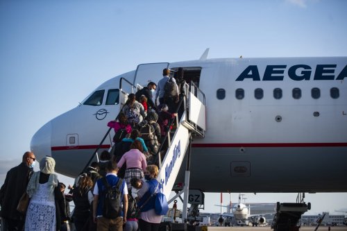 A group of recognized asylum seekers from the Moria camp, board a plane for Germany as part of the EU relocation program from Greek islands' hotspots on October 16, 2020 at Athens International Airport Eleftherios Venizelos in Athens, Greece [Dimitris Lampropoulos - Anadolu Agency]