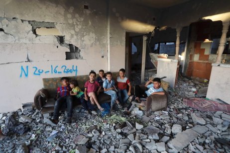 Palestinian children are seen inside a building damaged by the Israeli attacks in Beit Lahia, Gaza on June 07, 2021. Palestinians continue their daily lives amid rubbles, damaged and destroyed buildings and cars. ( Ashraf Amra - Anadolu Agency )