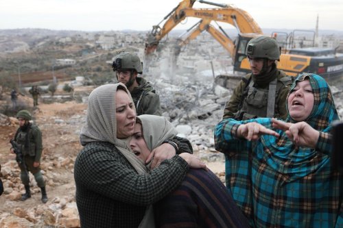 Palestinian residents react as their house, located in Area C, is demolished by Israeli forces allegedly for being "unlicensed", in Hebron, West Bank.[Mamoun Wazwaz - Anadolu Agency]