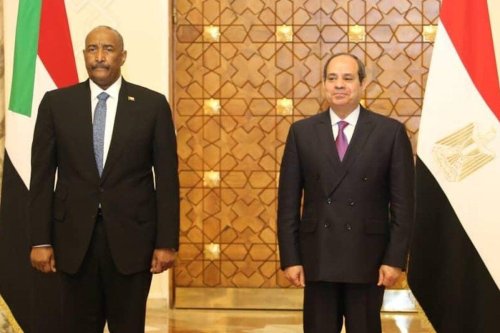Abdul Fattah al-Burhan (L), Chairman of the Sudanese Sovereignty Council, and Egyptian President Abdel Fattah Al-Sisi (R) pose for a photo during their meeting at Al-Ittihadiya Palace in Cairo, Egypt on March 30, 2022 [Sudan Press Office/Anadolu Agency]