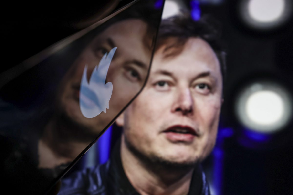 In this photo illustration, the image of Elon Musk is displayed on a computer screen and the logo of twitter on a mobile phone [Muhammed Selim Korkutata - Anadolu Agency]