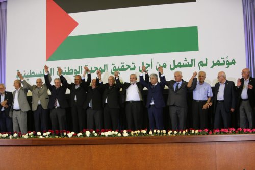 President of Algeria Abdelmadjid Tebboune (7th R) and leaders of 14 Palestinian groups are seen on the stage after Palestinian factions signed a reconciliation agreement at the Congress Palace in Algiers, Algeria on October 13, 2022. [Fazil Abd Erahim - Anadolu Agency]