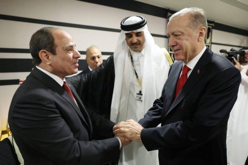 Turkish President Recep Tayyip Erdogan shakes hands with President of Egypt Abdel Fattah el-Sisi as they attend reception hosted by Qatari Emir Sheikh Tamim bin Hamad Al Thani on the occasion of the opening ceremony of the 2022 FIFA World Cup in Qatar [Murat Kula/Anadolu Agency]