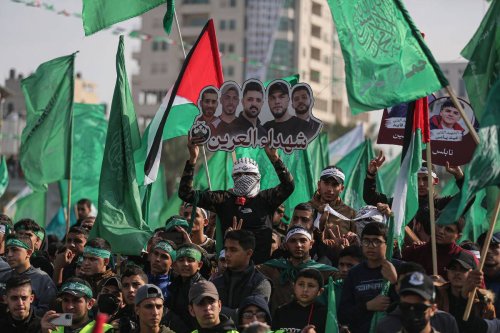 Palestinians attend an event marking the 35th anniversary of the establishment of Hamas as they wave Palestinian and Hamas flags in Gaza City, Gaza [Mustafa Hassona - Anadolu Agency]