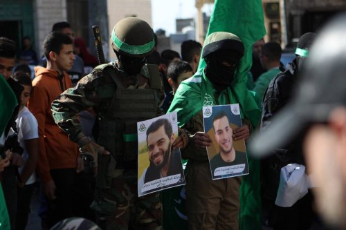 Palestinians attend an event marking the 35th anniversary of the establishment of Islamic Resistance Movement (Hamas) as they carry Palestinian and Hamas flags along with banners, in Beit Ummar town of Hebron, West Bank on December 16, 2022 [Mamoun Wazwaz - Anadolu Agency]