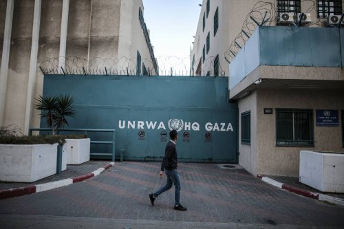 A man walks in front of the United Nations Relief and Works Agency (UNRWA) [Ali Jadallah - Anadolu Agency]