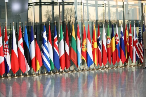 Member country flags are placed on the first day of the NATO Defence Ministers' Meeting [Dursun Aydemir - Anadolu Agency]