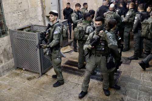Israeli police force people out of the Chain Gate as they raid Masjid al-Aqsa in Jerusalem on April 05, 2023 [Mostafa Alkharouf/Anadolu Agency]
