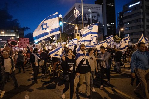 Demonstrators holding placards and Israeli flags gather for a rally to protest the Israeli government's judicial overhaul bill in Tel Aviv, Israel on April 29, 2023 [Mostafa Alkharouf - Anadolu Agency]