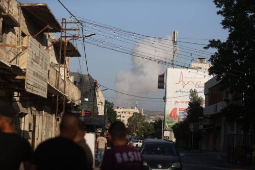 Smoke rises from the buildings after Israeli forces conducted airstrikes and raid on the city of Jenin, West Bank on July 03, 2023. [Issam Rimawi - Anadolu Agency]