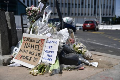 People lay flower and banner to memory of Nahel, near to where was Nahel's killed, in Nanterre, France on July 03, 2023 [Firas Abdullah/Anadolu Agency]
