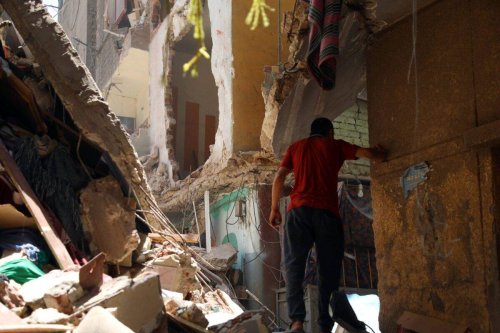 A civilian looks at the collapsed 4-storey building in Cairo, Egypt on July 17, 2023 [Fareed Kotb/Anadolu Agency]