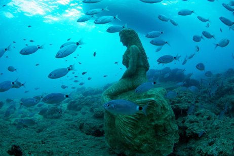 Fishes pass by an underwater statue at the Side Underwater Museum, Turkiye's first underwater museum, in Manavgat district of Antalya, Turkiye on June 19, 2023. [ Tahsin Ceylan - Anadolu Agency]
