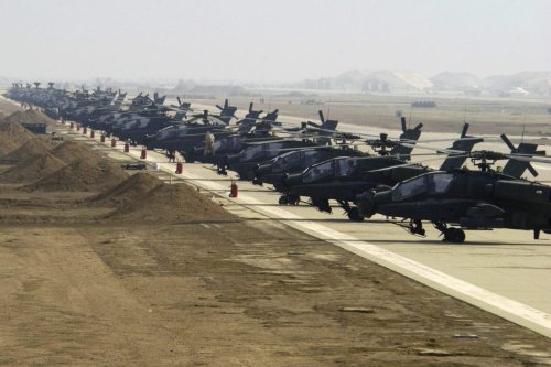 US Army Apache Longbow helicopters line the ramp at the airfield in Ein Al-Assad military base, Iraq, as seen on 7 January 2004 [SSGT Suzanne Jenkins, USAF]