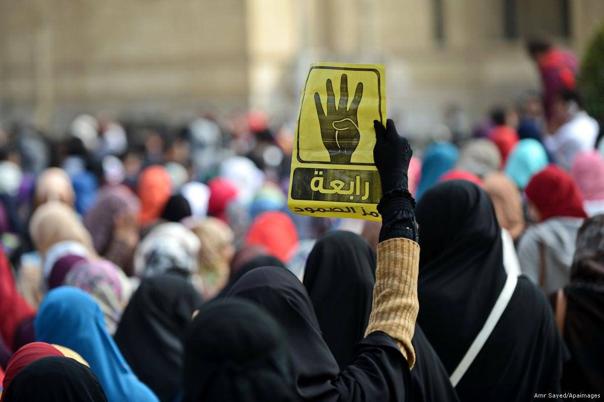 An Egyptian student holds the Rabaa sign during a protest against the military rule. [Amr Sayed/Apaimgaes]