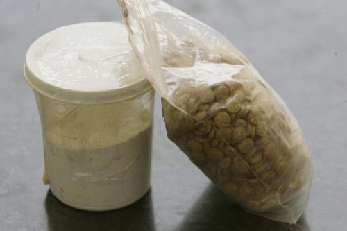 Captagon pills are displayed along with a cup of cocaine at an office of the Lebanese Internal Security Forces in Beirut on June 11, 2010 [JOSEPH EID/AFP via Getty Images]