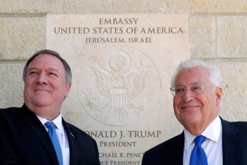 US Secretary of State Mike Pompeo (L) and US ambassador to Israel David Friedman stand next to the dedication plaque at the US embassy in Jerusalem on March 21, 2019 [JIM YOUNG/AFP via Getty Images]