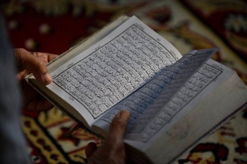 A Muslim man reading the Quran on May 06, 2019 [Narayan Maharjan/NurPhoto via Getty Images]