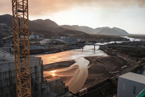 A general view of the Blue Nile river as it passes through the Grand Ethiopian Renaissance Dam (GERD), near Guba in Ethiopia, on 26 December 2019. - The Grand Ethiopian Renaissance Dam, a 145-metre-high, 1.8-kilometre-long concrete colossus is set to become the largest hydropower plant in Africa. Across Ethiopia, poor farmers and rich businessmen alike eagerly await the more than 6,000 megawatts of electricity officials say it will ultimately provide. Yet as thousands of workers toil day and night to finish the project, Ethiopian negotiators remain locked in talks over how the dam will affect downstream neighbours, principally Egypt. [EDUARDO SOTERAS/AFP via Getty Images]
