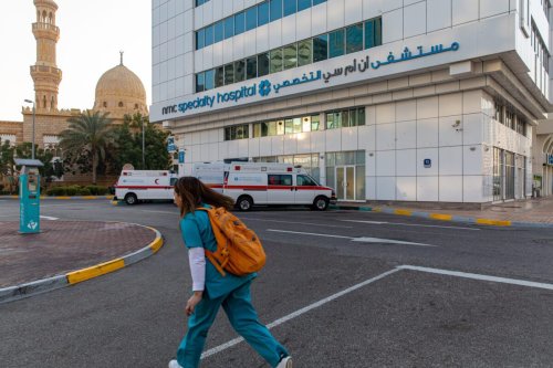 A health worker passes the NMC Speciality Hospital, operated by NMC Health Plc, in Dubai, United Arab Emirates, on Sunday, March 1, 2020 [Christopher Pike/Bloomberg via Getty Images]