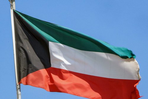This picture taken on September 20, 2020 shows a Kuwaiti national flag flying from a mast in Kuwait City [YASSER AL-ZAYYAT/AFP via Getty Images]