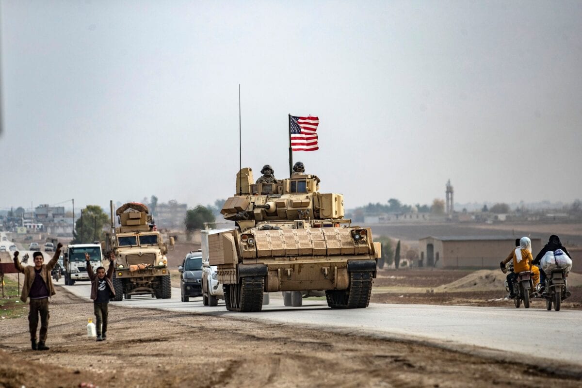 US troops patrol in their military vehicles near the Syrian border on 17 December 2020 [DELIL SOULEIMAN/AFP via Getty Images]