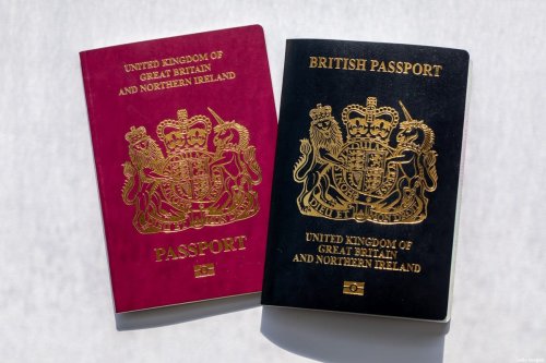 An older copy of the British National (Overseas) passport, left with a newer copy arranged in Hong Kong, China, on Saturday, Jan. 30, 2021 [Paul Yeung/Bloomberg via Getty Images]