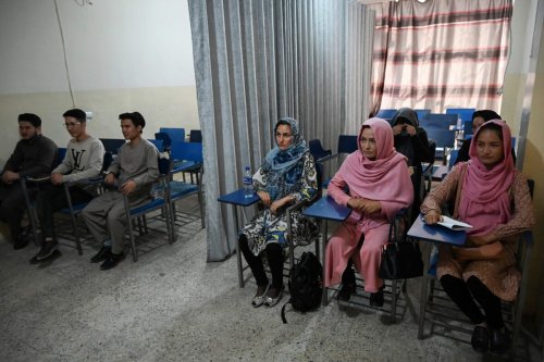 Students attend a class bifurcated by a curtain separating males and females at a private university in Kabul on September 7, 2021, to follow the Taliban's ruling. (Photo by Aamir QURESHI / AFP) (Photo by AAMIR QURESHI/AFP via Getty Images)