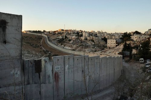 A picture shows Israel's separation barrier cutting through the West Bank town of Abu Dis on the outskirts of Jerusalem on November 8, 2021 [HAZEM BADER/AFP via Getty Images]