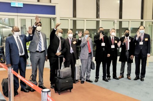 This picture taken on February 8, 2022 and released on February 9, 2022 by Taiwans Central News Agency (CNA) shows Somaliland's Foreign Minister Essa Kayd Mohamoud (3rd L) waving with his delegation after arriving at Taoyuan International Airport outside Taipei. [STR/CNA/AFP via Getty Images]