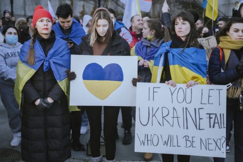 Demonstrators during a protest against the Russian invasion of Ukraine in front of the United Nations Headquarters in New York, US, on February 27, 2022 [Ismail Ferdous/Bloomberg via Getty Images]