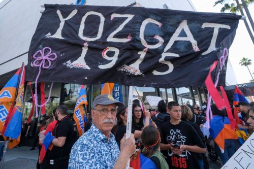 A man holds a sign reading 'Yozgat 1915' during a protest outside of the Turkish Consulate on the anniversary of the Armenian genocide on April 24, 2022 in Beverly Hills, California [RINGO CHIU/AFP via Getty Images]