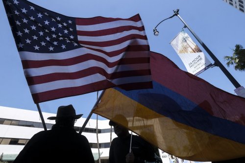 People carrying a USA and Armenia flag protest outside of the Turkish Consulate on the anniversary of the Armenian genocide in a demonstration organized by the Armenian Youth Federation of the Western United States on 24 April 2022 in Beverly Hills, California. [RINGO CHIU/AFP via Getty Images]