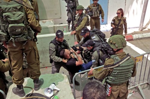 Israeli security forces evacuate a Palestinian man who was denied passage at a checkpoint to reach the city of Jerusalem to attend the last Friday prayers of Ramadan in the al-Aqsa mosque compound, on April 29, 2022 [HAZEM BADER/AFP via Getty Images]