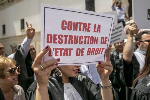 Judges gathered in front of the Palace of Justice building to protest the dismissal of 57 judges with the controversial judicial decree of Tunisian President Kais Saied in Tunis, the capital of Tunisia on June 23, 2022 [Yassine Gaidi/Anadolu Agency]