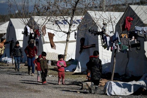 Children walk in a camp for Syrian refugee in Turkey set up by Turkish relief agency AFAD in the Islahiye district of Gaziantep [Photo by OZAN KOSE/AFP via Getty Images]