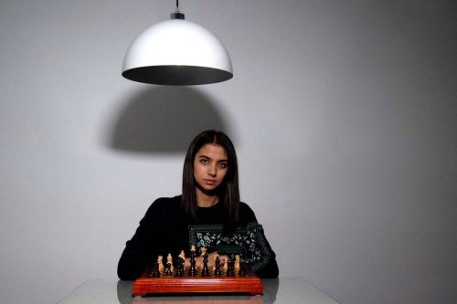 Iranian chess champion Sara Khadem poses for a photograph playing chess in the south of Spain on February 14, 2023. [CRISTINA QUICLER/AFP via Getty Images]