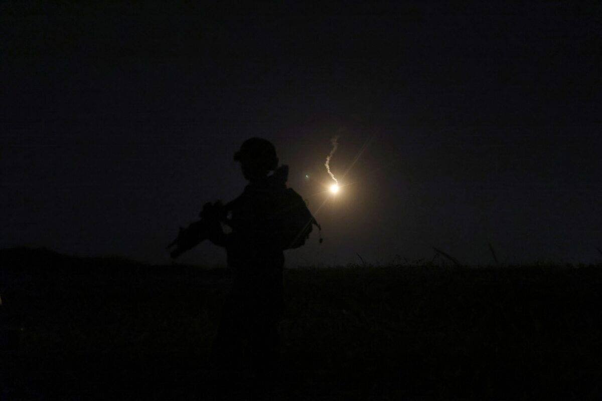 The silhouette of an Israeli soldier is outlined in the sky by a flare fired to search for a rocket that landed near Kibbutz Meitsar in the Israeli annexed Golan Heights, April 9, 2023 [JALAA MAREY/AFP via Getty Images]