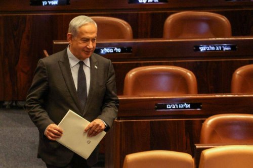 Israeli Prime Minister Benjamin Netanyahu walks to a seat at the Knesset, the Israeli Parliament, in Jerusalem on May 1, 2023 [MENAHEM KAHANA/AFP via Getty Images]