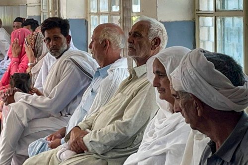 In this picture taken on June 20, 2023, relatives of migrants, who went missing after an overloaded trawler capsized and sank in the Ionian Sea, wait to provide DNA samples at a hospital in Bandli village, in Pakistan [SAJJAD QAYYUM/AFP via Getty Images]
