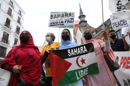 Saharawi women wearing masks display Saharawi flags during the demonstration on June 18, 2021 in Madrid, Spain [Isabel Infantes/Getty Images]