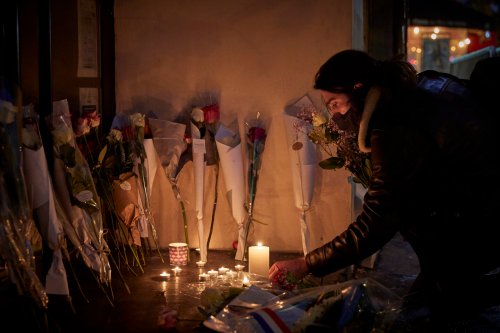 A Parisian lights a candle outside the Bataclan concert hall in memory of the victims who were killed during the 13th November 2015 Paris terror [Kiran Ridley/Getty Images]