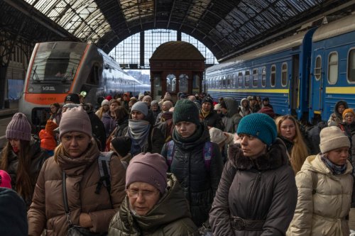 Passengers depart the railway station after disembarking trains from the east on March 11, 2022 in Lviv, Ukraine [Dan Kitwood/Getty Images]