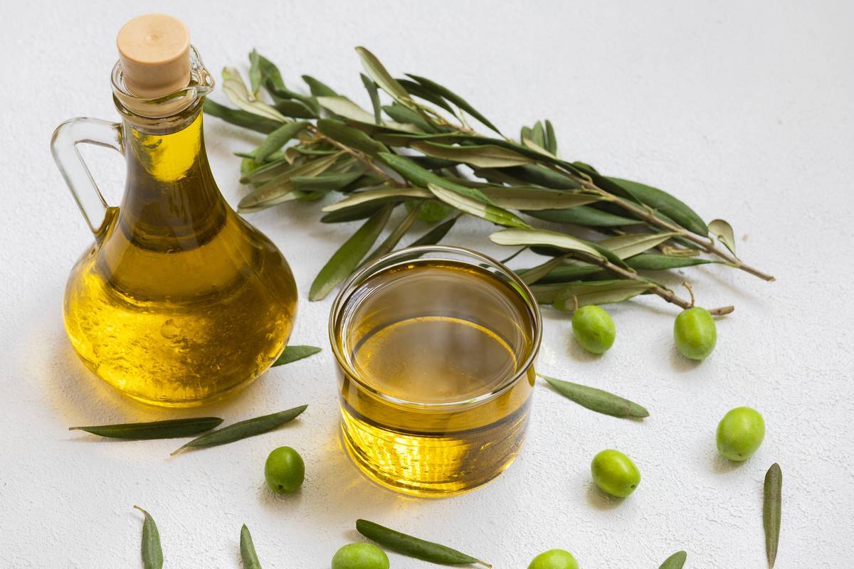 Image of raw olives and olive oil. [Photo via Getty Images]