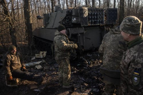 Members of a Ukrainian artillery unit, reload equipment and ammunition into a M109 self propelled artillery unit in Donetsk Region, Ukraine. [Photo by Chris McGrath/Getty Images]